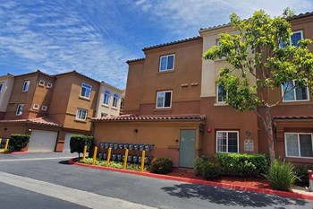 Entry to community with view of buildings and trees